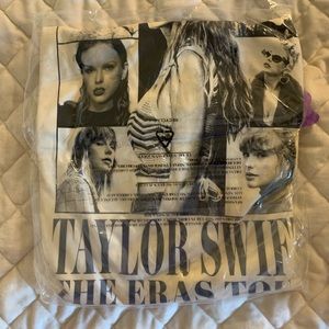 2X Eras Tour soft cream-colored shirt.